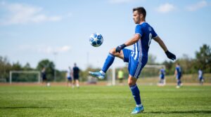 Player juggling a football with feet and thighs to improve touch and coordination