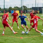 Group of football players doing rondo drill to improve passing and ball control under pressure