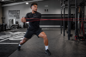 Football player training best core exercises for football players using Pallof press anti-rotation drill.