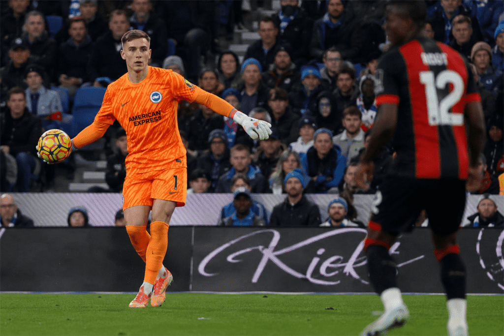 Bart Verbruggen making a full-stretch diving save for Brighton in a Premier League football match.
