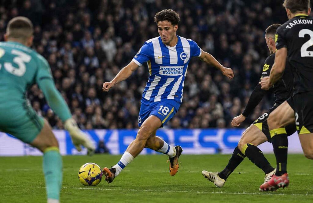 Charalampos Kostoulas dribbles forward in a Brighton & Hove Albion shirt during a Premier League match