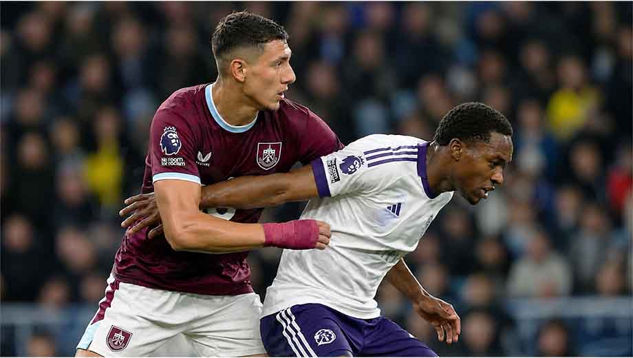 Maxime Estève battling an opposing attacker during a football match, highlighting why he is an upcoming defender to watch in 2026.