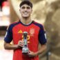 Pau Cubarsí biography featured image showing the Barcelona defender holding a Spain youth football trophy